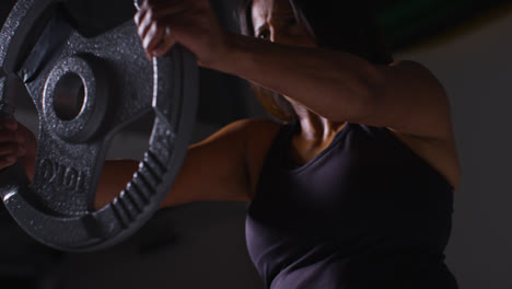 Close-Up-Studio-Shot-Of-Mature-Woman-Wearing-Gym-Fitness-Clothing-Lifting-Weights-For-Cardio-Exercise